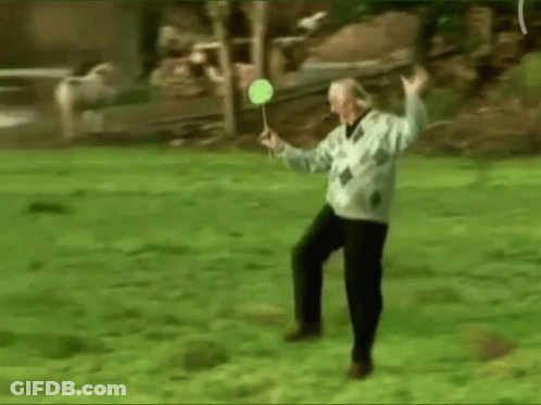 Elderly Man Playing Badminton In Park GIF
