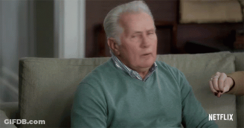 Elderly Man Sitting On Couch With Eyes Closed Netflix Logo GIF