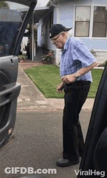 Elderly Man Standing Next To Open Car Trunk GIF