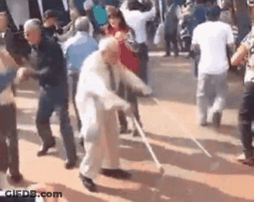 Elderly Man With Cane Dancing With Group GIF