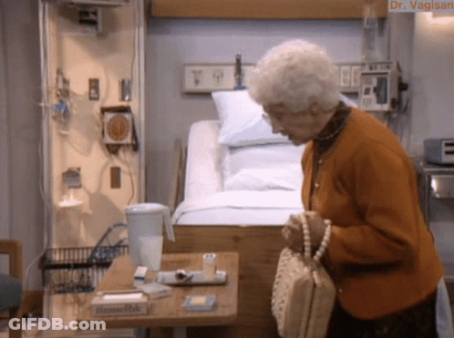Elderly Woman At Hospital Bed With Tissues GIF