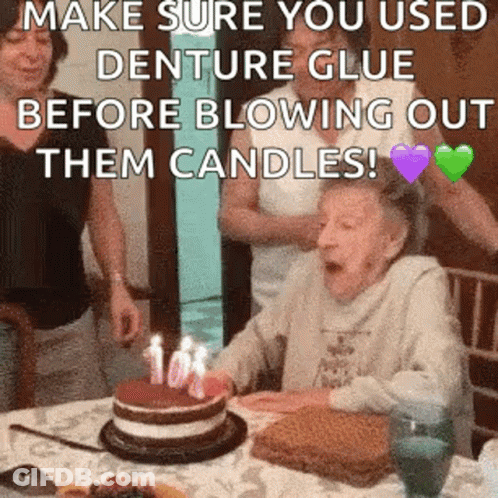 Elderly Woman Blowing Out Birthday Cake Candles GIF