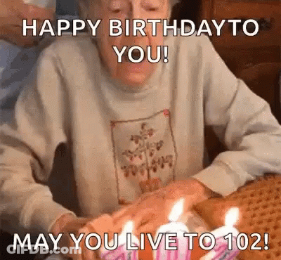 Elderly Woman Blowing Out Birthday Cake Candles GIF