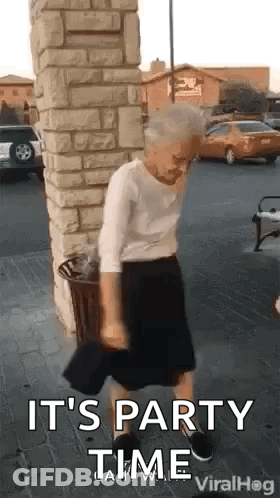 Elderly Woman Dancing By Brick Building GIF