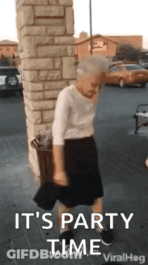 Elderly Woman Dancing In Brick Building Parking Lot GIF
