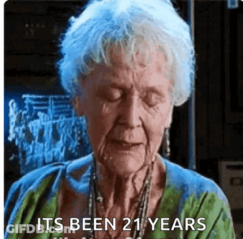 Elderly Woman Eyes Closed Saying It's Been 21 Years GIF