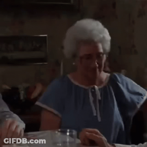 Elderly Woman Holding Framed Picture Of Two Dogs GIF
