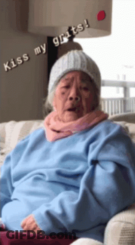 Elderly Woman In Beanie And Blue Sweater Says Kiss My Grits GIF