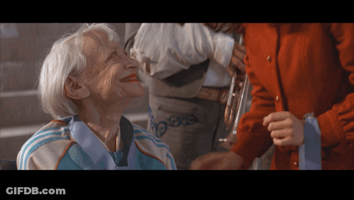 Elderly Woman In Blue And White Adidas Jacket Smiling GIF