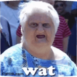 Elderly Woman In Blue Shirt Making Funny Face Saying Wat GIF