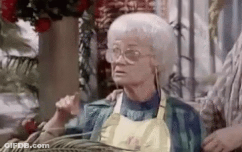 Elderly Woman In Glasses And Apron Sitting GIF