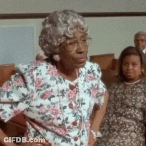 Elderly Woman In Glasses And Floral Shirt In Church GIF