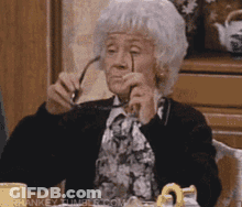 Elderly Woman In Glasses And White Hat Asking If Anyone Is Listening GIF