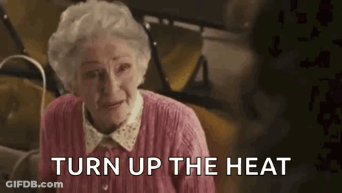 Elderly Woman In Pink Sweater Saying Turn Up The Heat GIF