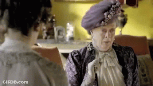 Elderly Woman In Purple Hat Talking To Another Woman GIF