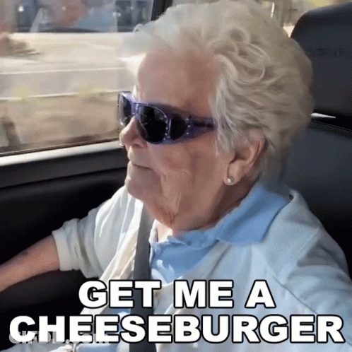 Elderly Woman In Sunglasses Driving Says Get Me A Cheeseburger GIF
