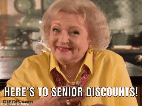 Elderly Woman In Yellow Shirt Says Here's To Senior Discounts GIF