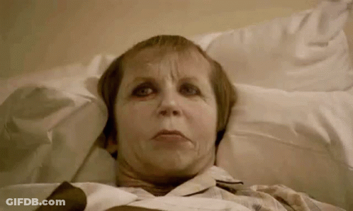 Elderly Woman Laying In Hospital Bed Making Funny Face GIF