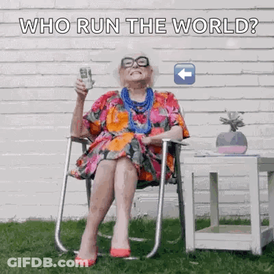 Elderly Woman Sitting Holding Remote And Phone GIF