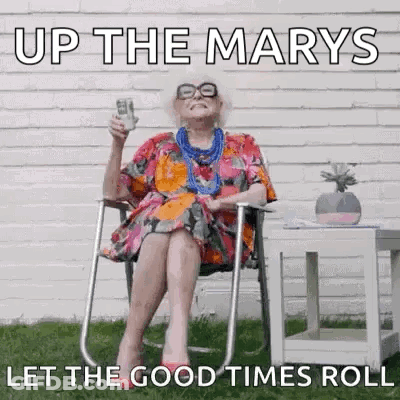 Elderly Woman Sitting In Chair Holding Beer GIF