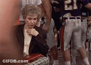 Elderly Woman Sitting In Front Of Football Player Number 21 GIF