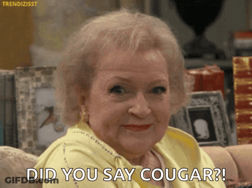 Elderly Woman Sitting On Couch Saying Did You Say Cougar GIF