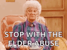 Elderly Woman Sitting With Tea And Coffee GIF