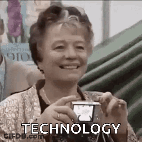 Elderly Woman Smiling Holding Camera With Technology GIF