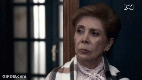 Elderly Woman Standing In Front Of Door GIF