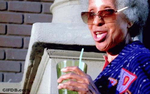 Elderly Woman Wearing Sunglasses Drinking Green Drink GIF
