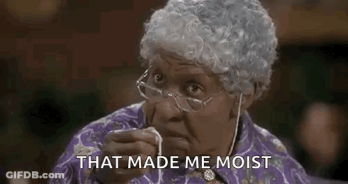 Elderly Woman With Glasses And Wig Eating Food GIF