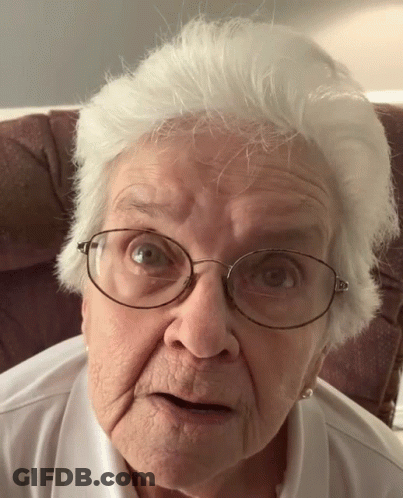 Elderly Woman With Glasses Looking At Camera GIF