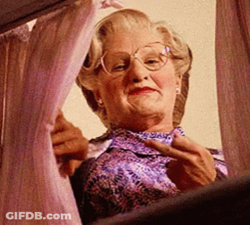 Elderly Woman With Glasses Looking Out Window GIF