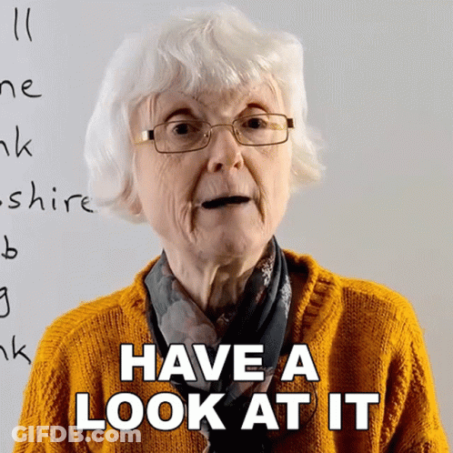 Elderly Woman With Glasses Saying Have A Look At It GIF