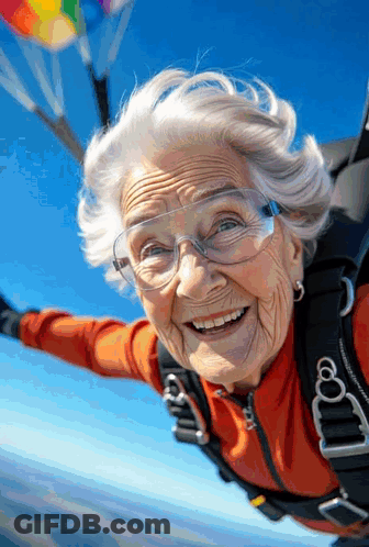 Elderly Woman With Glasses Smiling In Parachute GIF