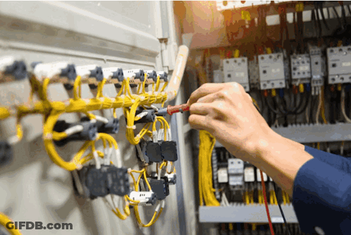 Electrician Working On Circuit Board With Multimeter GIF