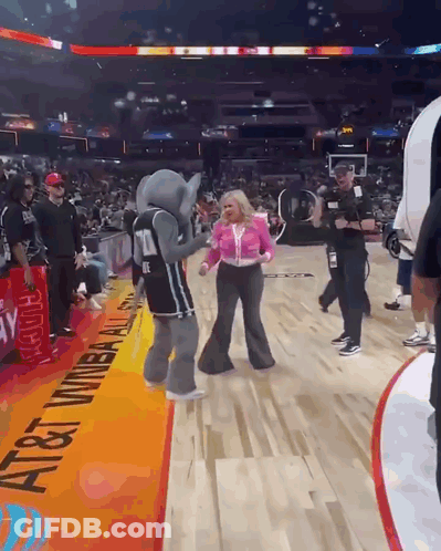 Elephant Mascot Dancing With Woman On Basketball Court GIF