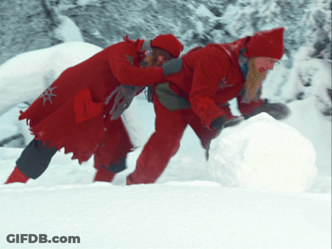 Elf Santa Rolling A Snow GIF