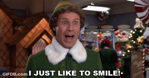 Elf Saying I Just Like To Smile Front Christmas Tree GIF