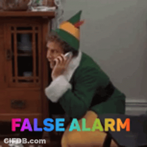 Elf Talking On Cell Phone Saying False Alarm GIF