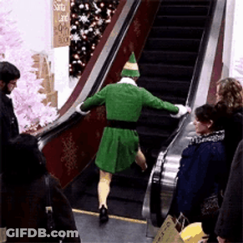 Elf Trying To Get Onto An Escalator GIF
