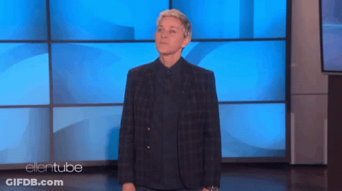 Ellen Degeneres Is Standing In Front Of A Blue Wall On Ellentube GIF
