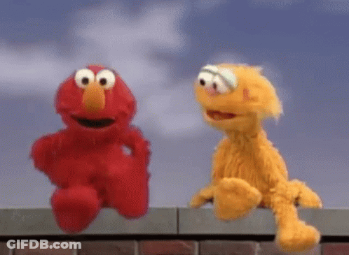 Elmo And Fozzie Are Sitting On A Brick Wall . GIF