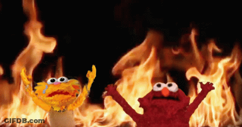 Elmo And Garlic Bread In Front Of Fire GIF