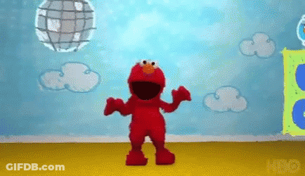 Elmo From Sesame Street Is Dancing In A Room With A Disco Ball . GIF