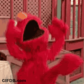 Elmo From Sesame Street Is Dancing In A Room With His Arms Outstretched . GIF