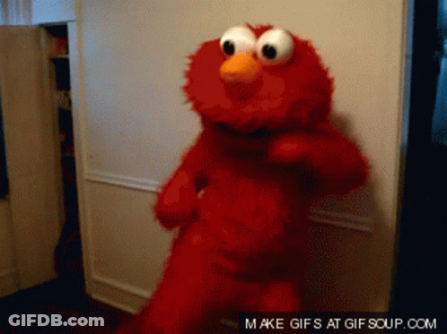 Elmo From Sesame Street Is Dancing In Front Of A Door GIF
