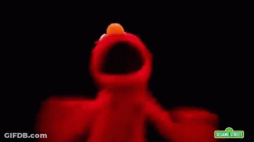 Elmo From Sesame Street Is Dancing In The Dark With A Black Background . GIF