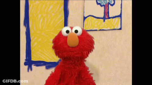 Elmo From Sesame Street Is Standing In Front Of A Drawing On The Wall GIF
