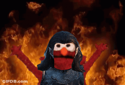 Elmo From Sesame Street Is Standing In Front Of A Fire Background GIF
